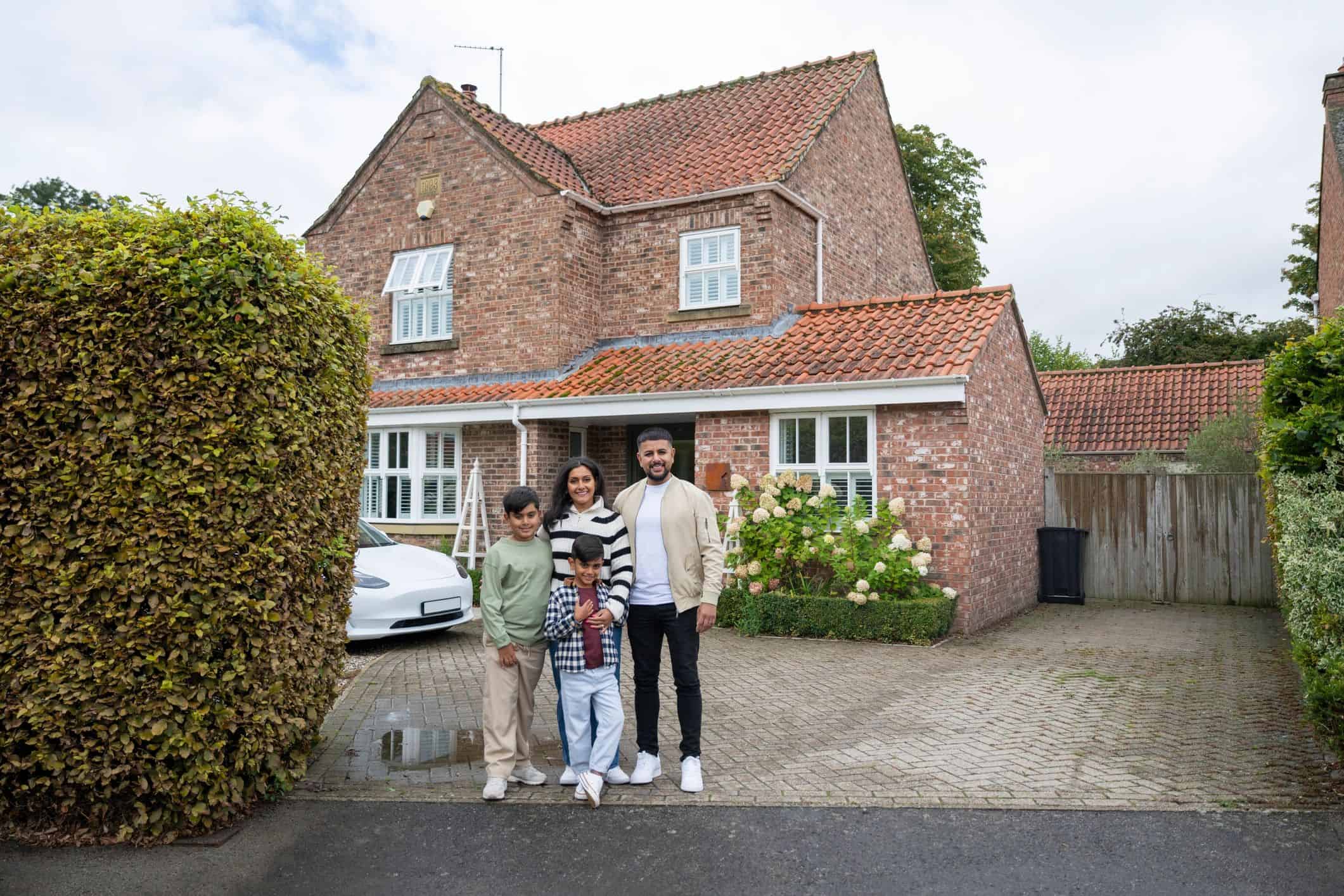Family outside a completed home project